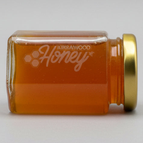 Jar of Kirrawood Honey on a wooden surface