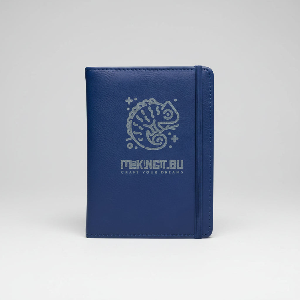 Blue notebook with a chameleon design and text held by a hand.
