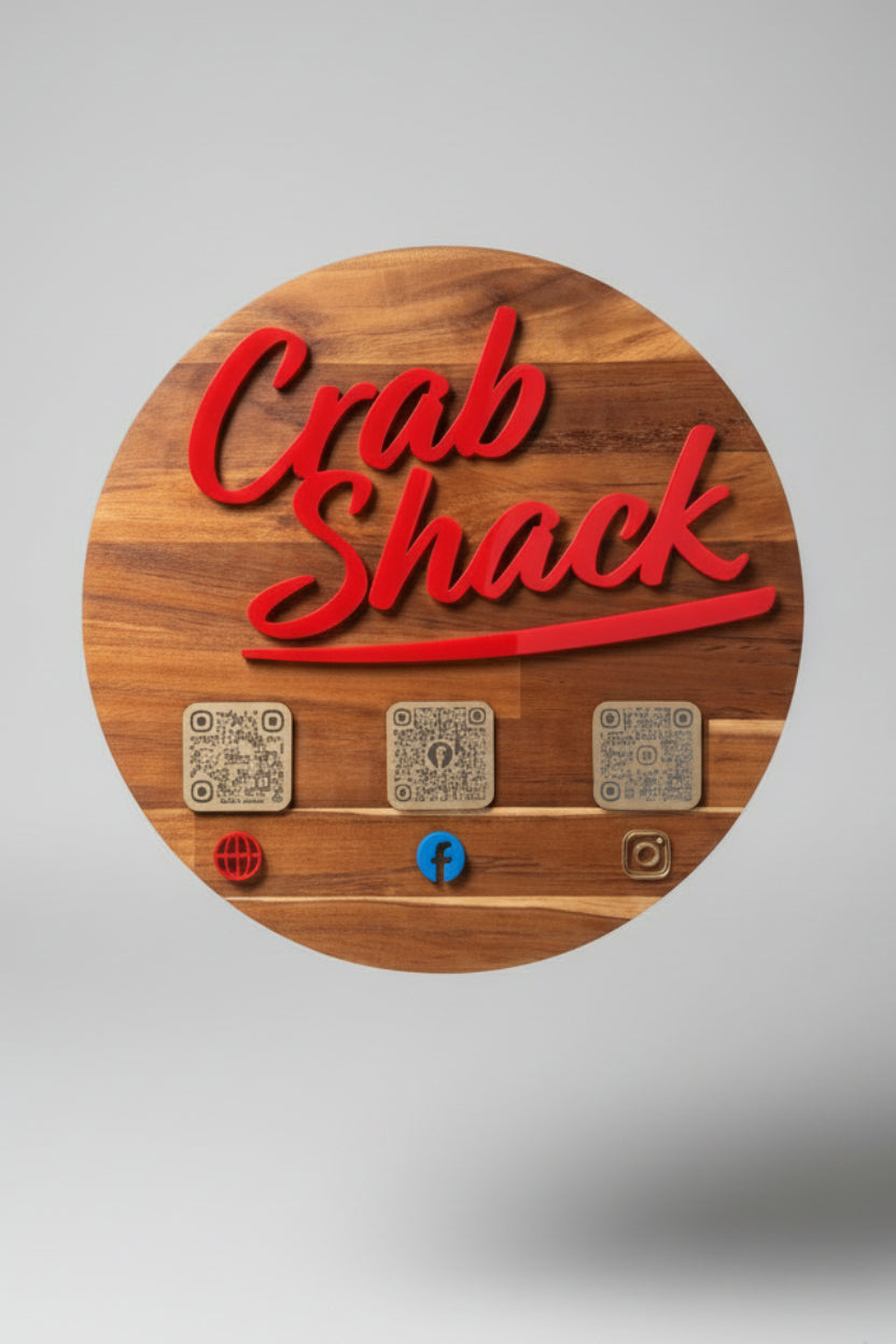 Wooden sign with Acrylic 'Crab Shack' in red text, along with QR Codes for social media channels.
