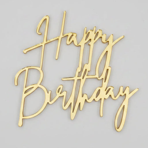 Gold mirror acrylic script cupcake topper spelling 'Happy Birthday' on a textured white background
