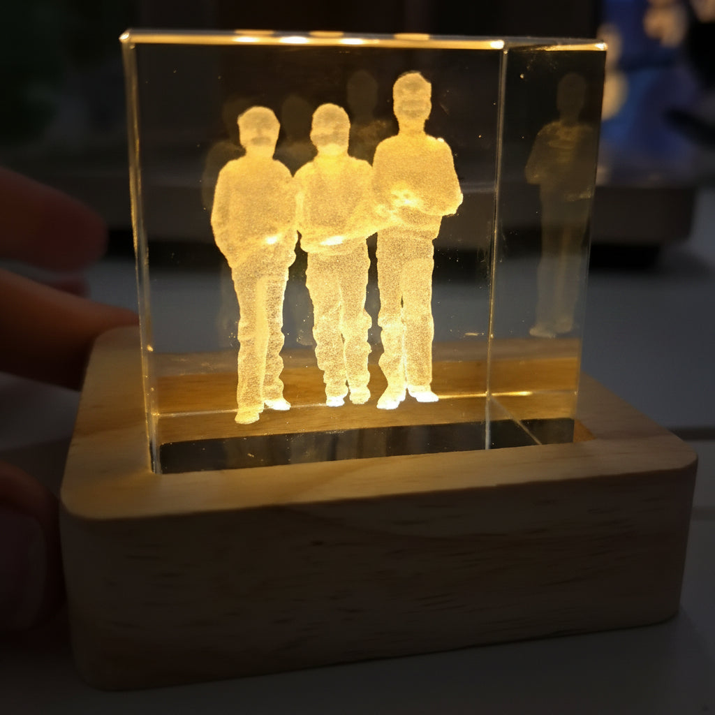 Internally engraved Crystal with three figures on a wooden base