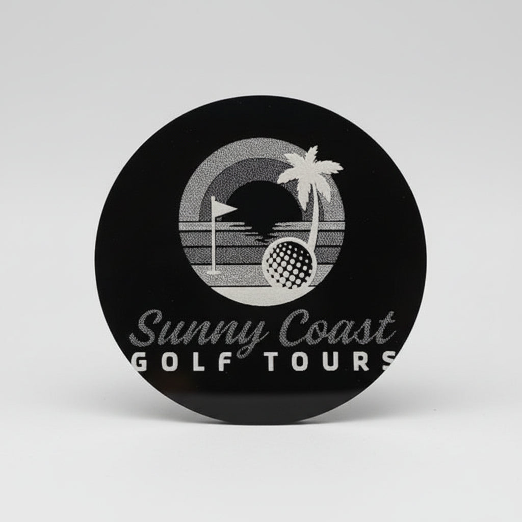 Close-up of a logo for Sunny Coast Golf Tours on black acrylic.