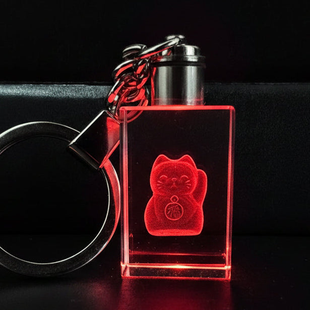 Clear rectangular keychain with internally engraved design on a dark background