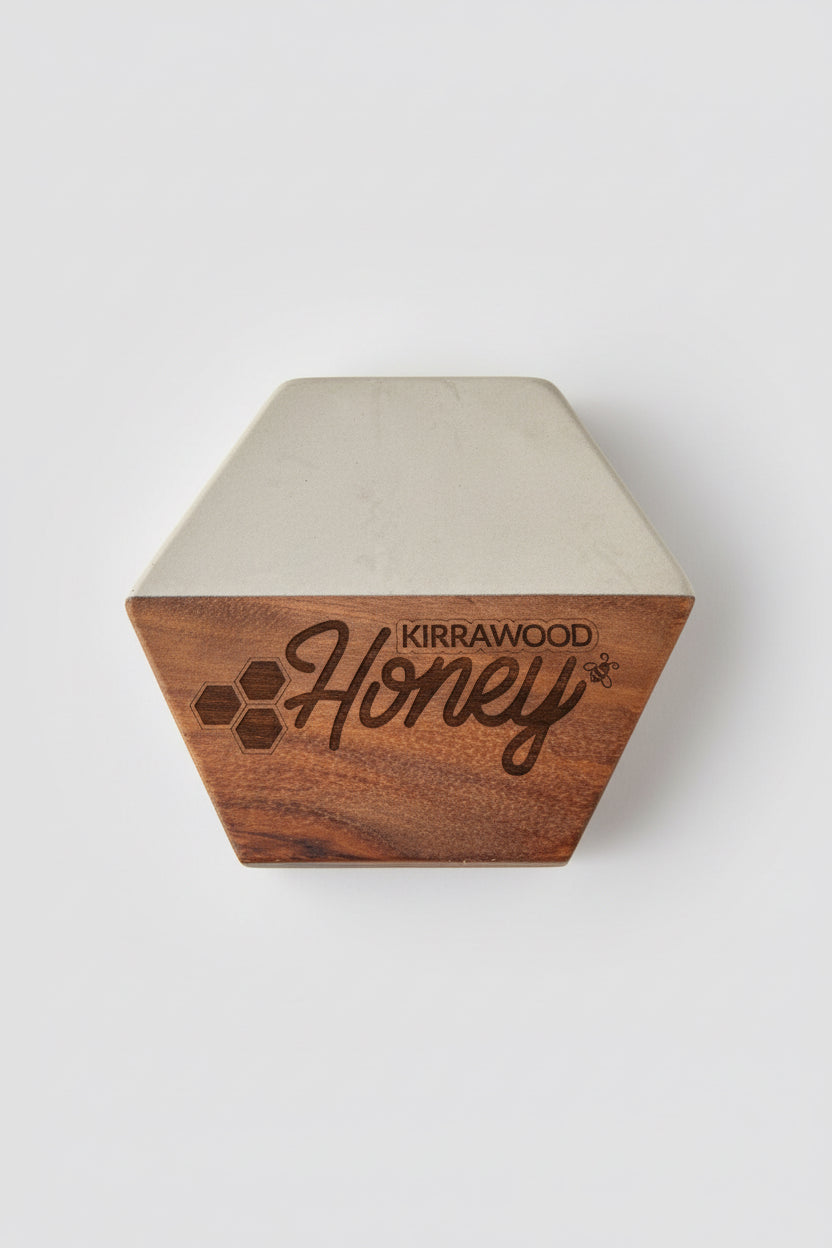 Hexagonal Marble Timber Coaster with 'Kirrawood Honey' engraving on a laser cutting machine.