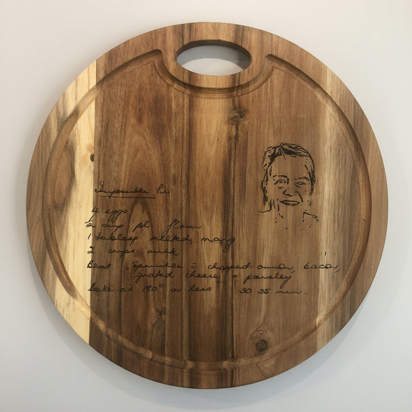 Wooden cutting board with engraved text and portrait