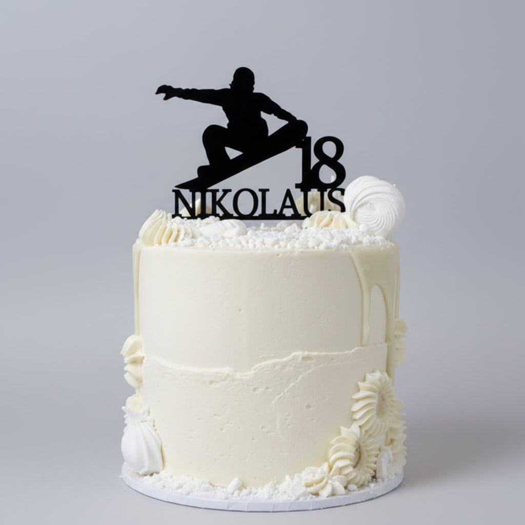 White cake with a black silhouette of a person and '18 Nikolaus' black cake topper on top