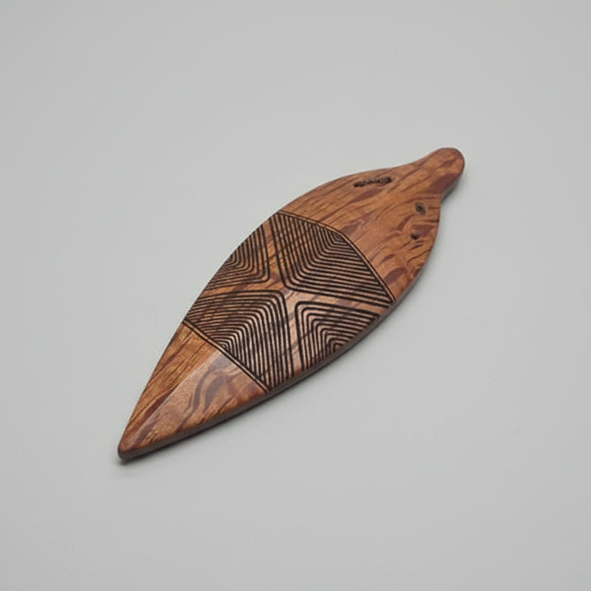 Wooden pendant with intricate engraved design