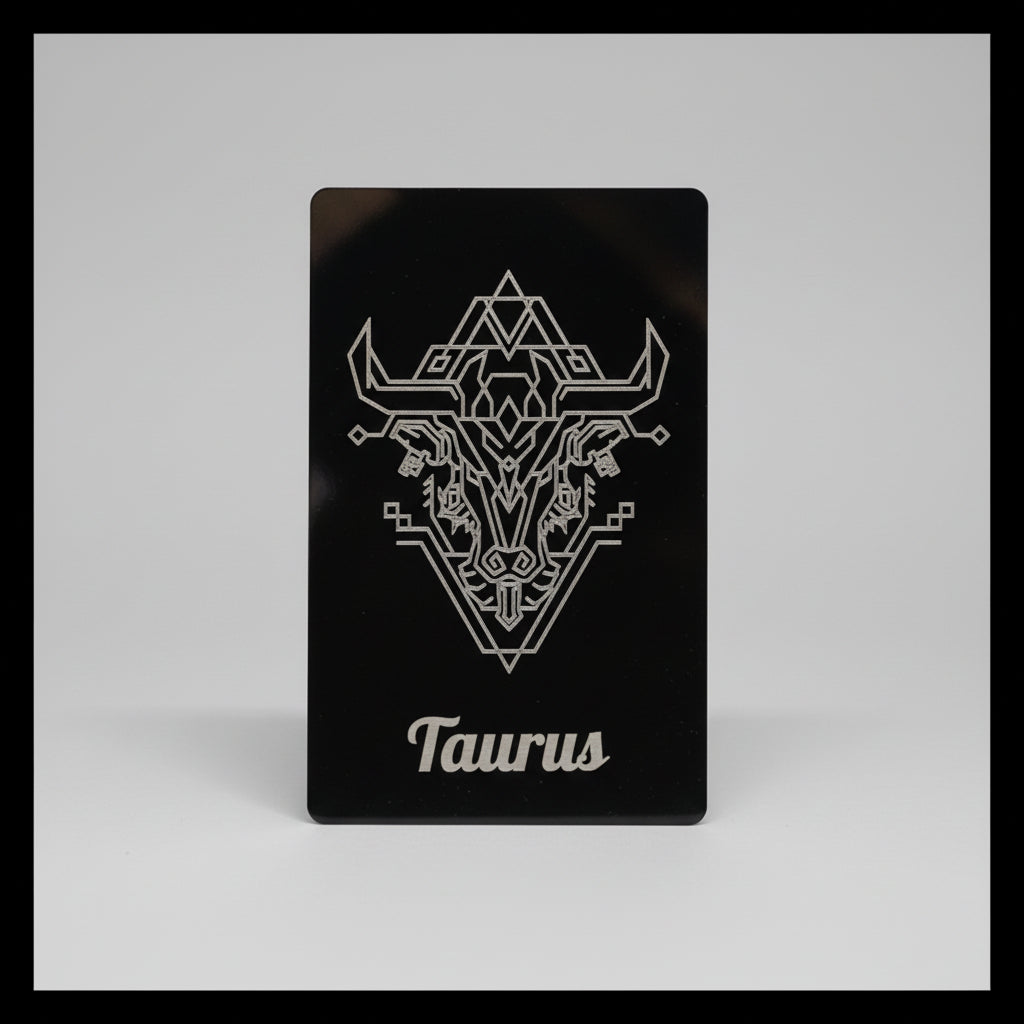 Black card with white Taurus zodiac symbol.