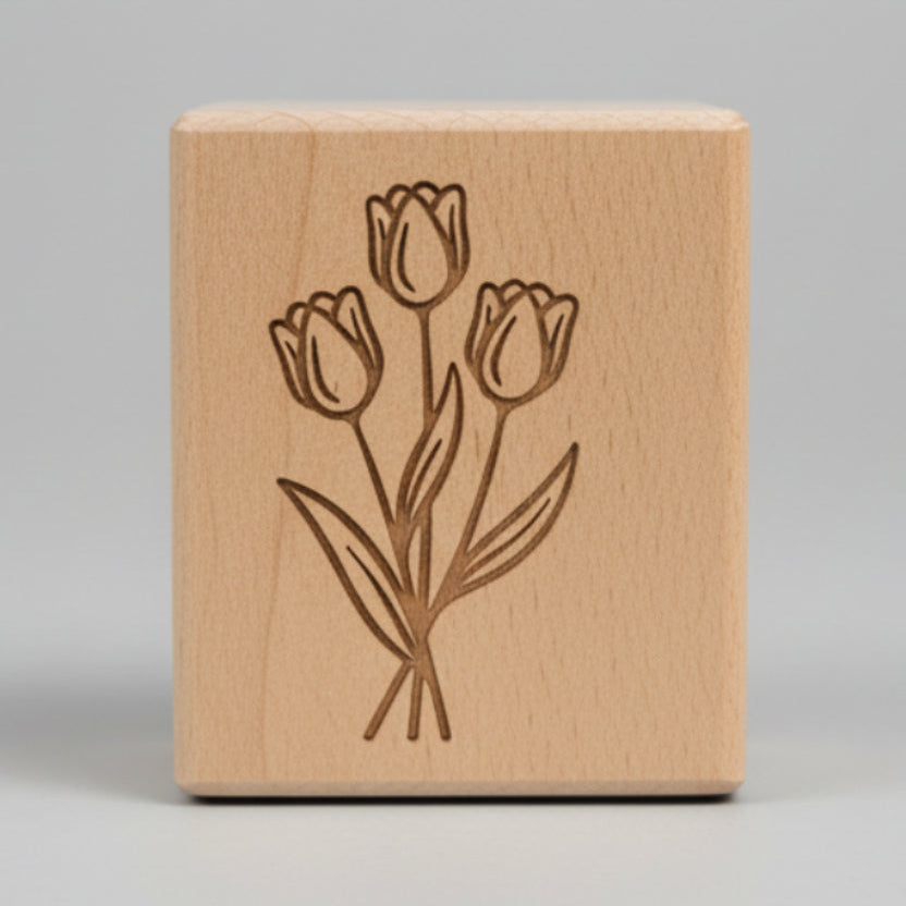 Wooden block with engraved tulip design.