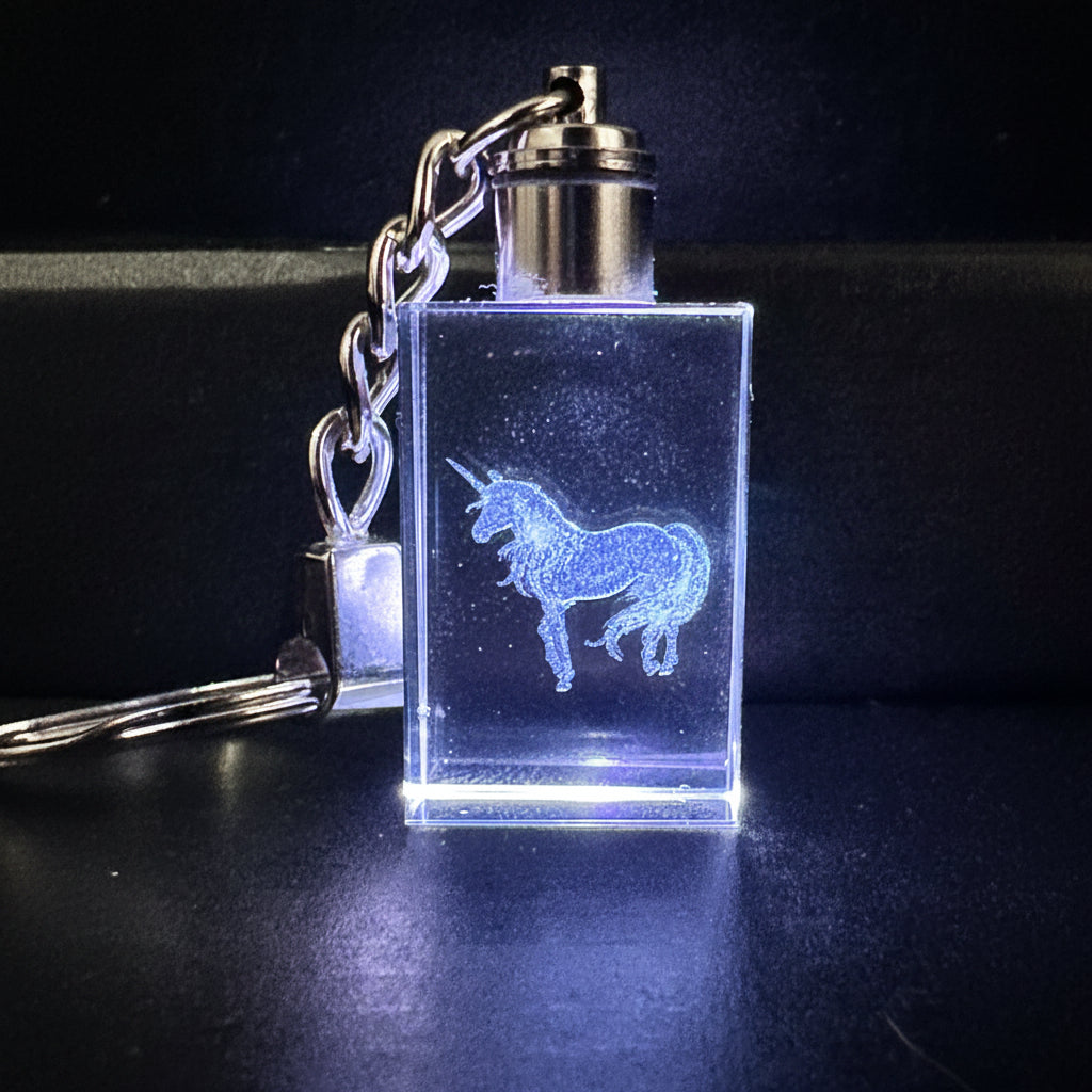 Clear keychain with engraved design on a dark background
