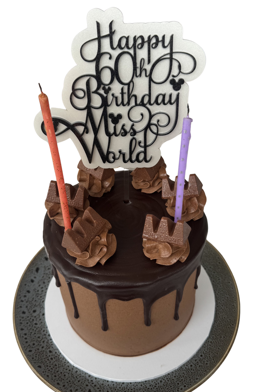 Chocolate cake with chocolate flowers and candles on a white background